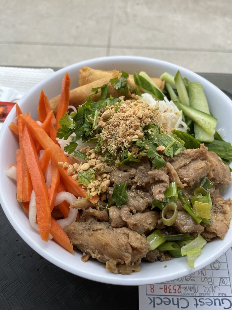 Vermicelli bowl with grilled chicken, egg roll, pickled carrots and herbs