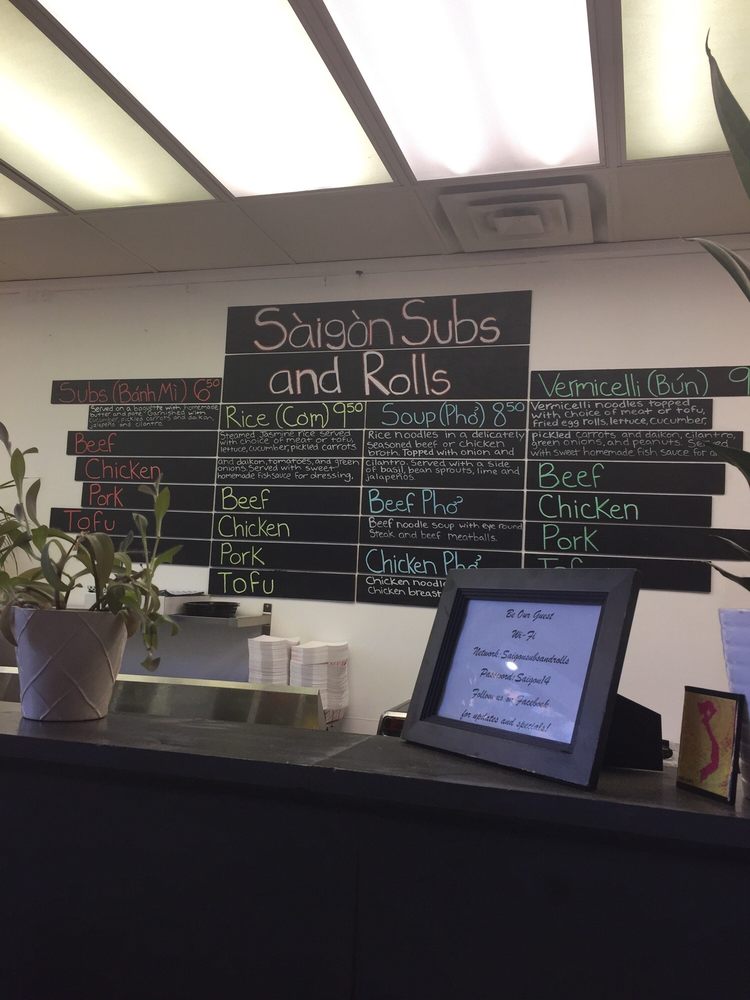 The Saigon Subs & Rolls chalkboard menu above the counter